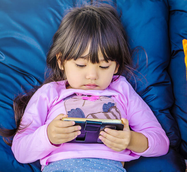 Child playing games on a mobile device
