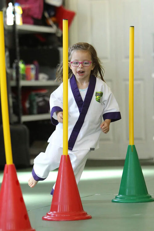Little Dragons Halifax student showing agility running in between cones