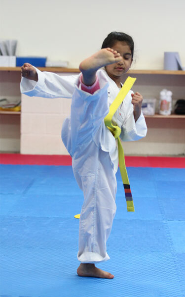 Junior Taekwondo student kicking