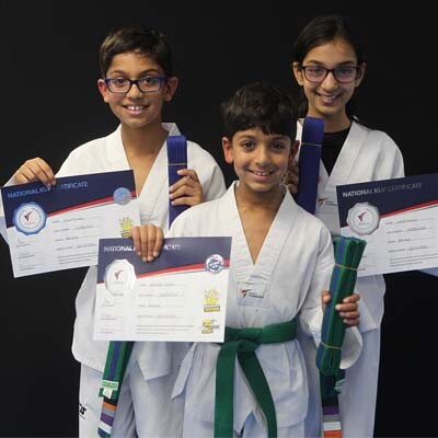 Taekwondo kids showing their new belts